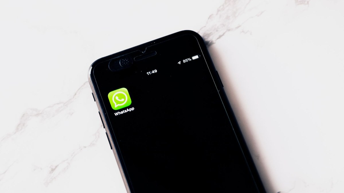Business professional comparing CRM dashboard with WhatsApp messages